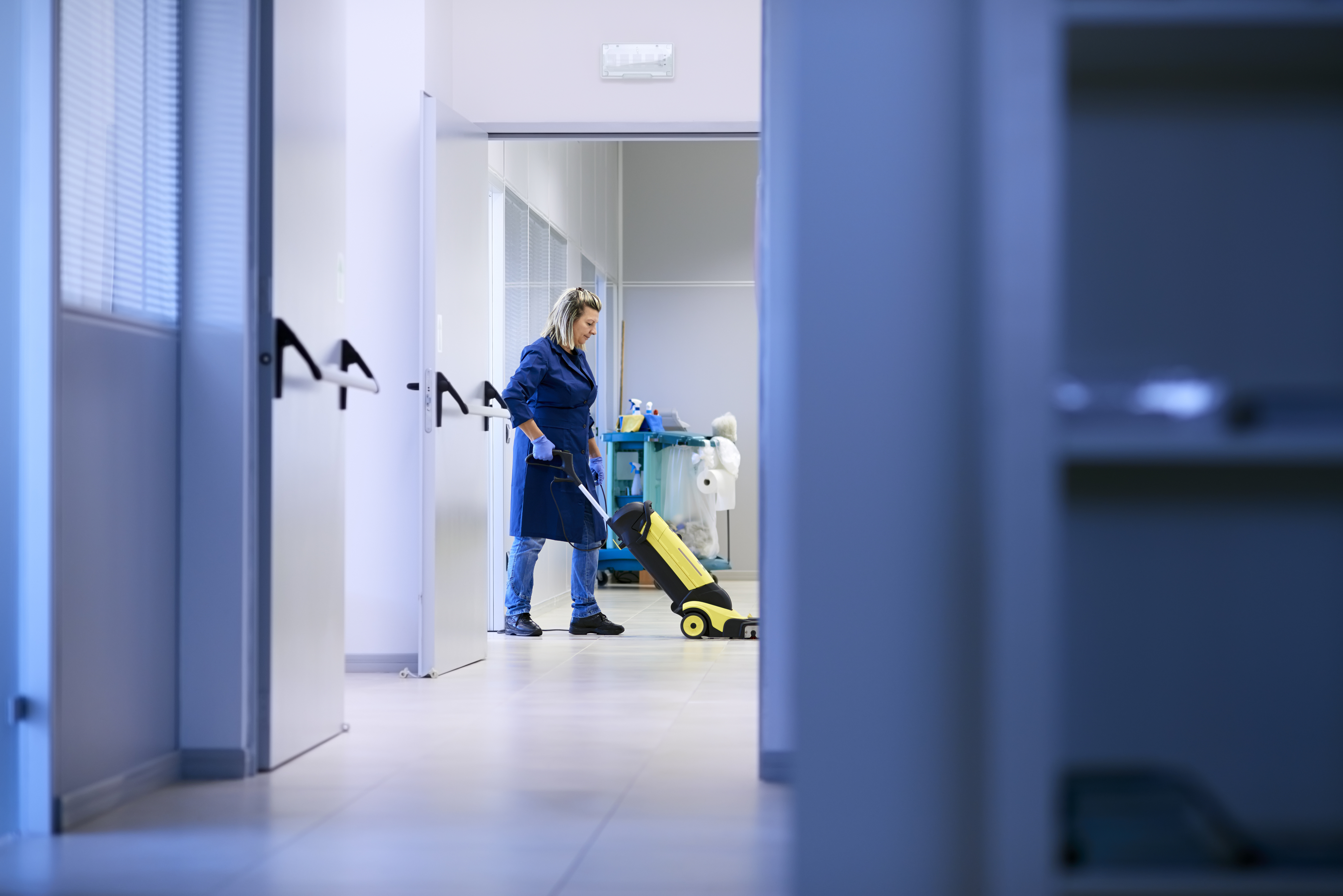 Women at workplace, professional female cleaner washing floor in Woman working, professional maid cleaning and washing floor with machinery in industrial building